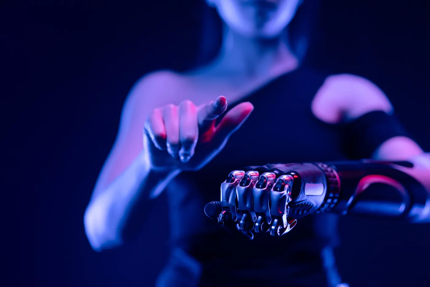 Human hand reaching toward a robotic hand